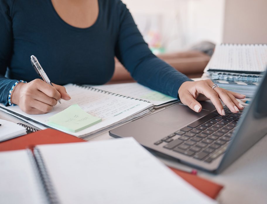 notebook-laptop-and-writing-hands-of-black-woman-o-ZDYYSGP